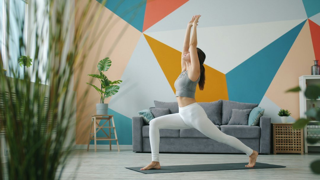 Woman practicing yoga indoors on a mat