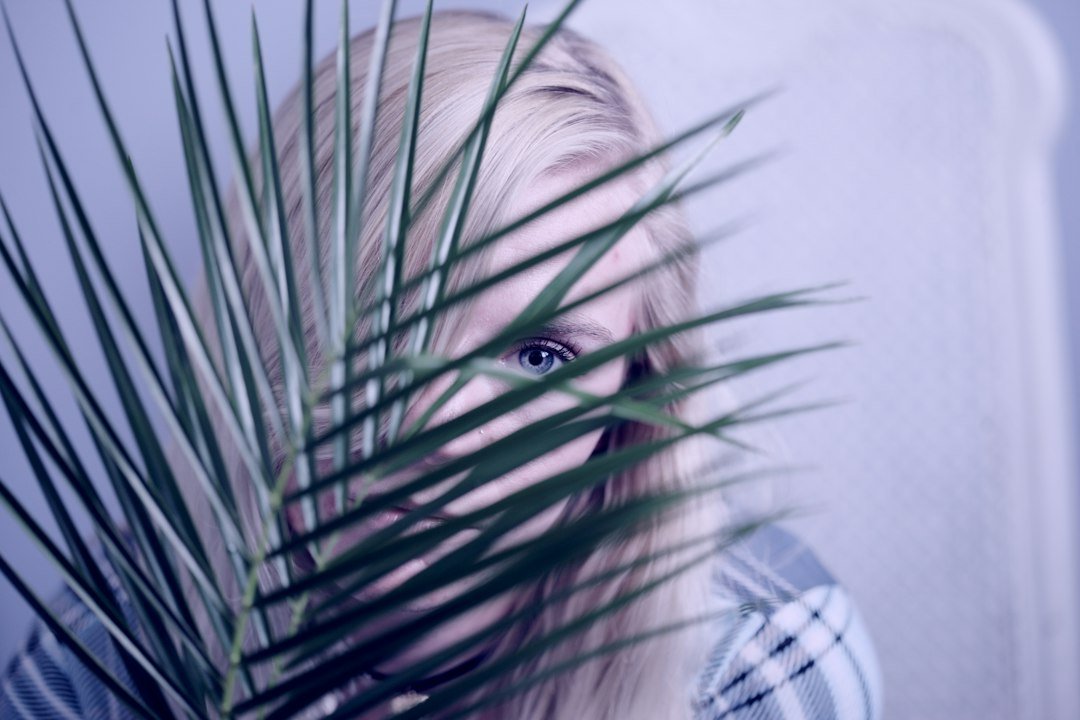 Woman surrounded by indoor plants at home
