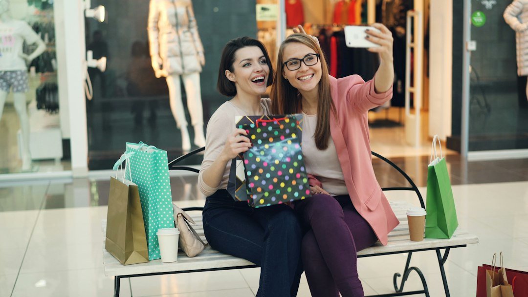 Women smiling together while shopping for gifts